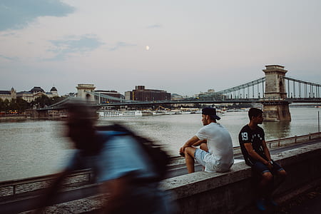 time-lapsed photography of two men sitting near each other near river thumbnail