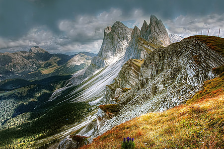 white and green mountain under dark clouds thumbnail