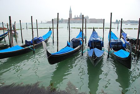 blue boat on body of water during daytaime thumbnail