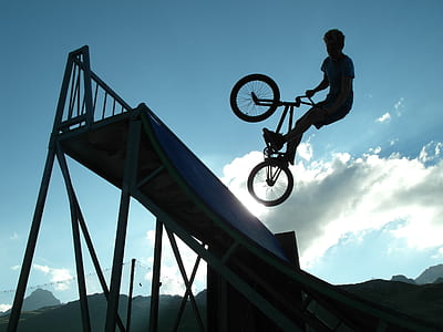 man riding BMX bike while making tricks thumbnail