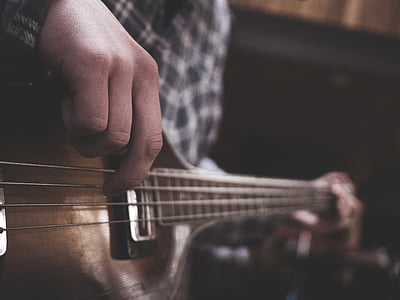 person playing brown string instrument thumbnail
