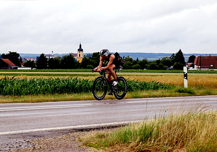 man riding road bike during daytime thumbnail
