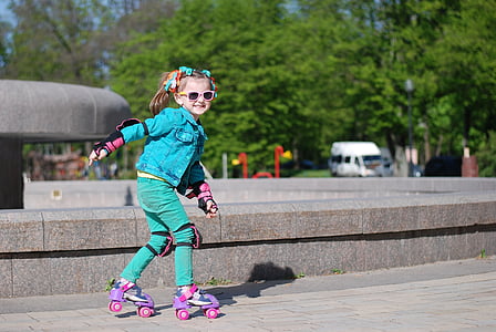 girl in blue jacket and green pants skating near fountain thumbnail