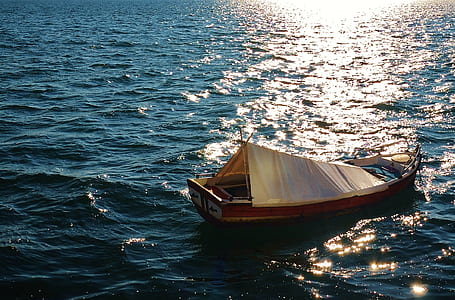 brown wooden boat in the middle of the sea thumbnail