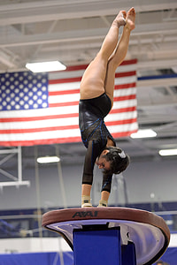 woman doing gymnastics near USA flag thumbnail