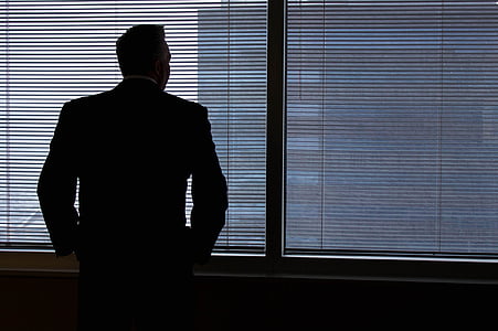 man standing in front of building window thumbnail