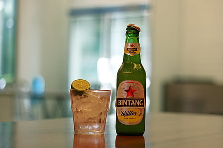 Bintang bottle beside clear drinking glass thumbnail