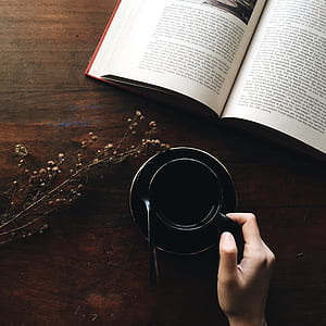 person holding black cut of coffee mug thumbnail