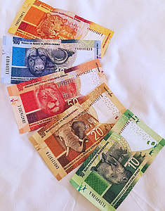 five banknotes on white textile thumbnail