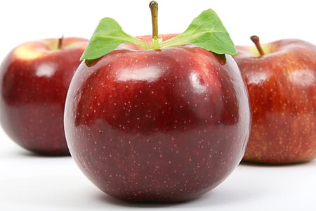 three red Malus domestica apples on white suface thumbnail
