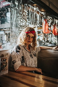 woman sitting beside wooden table thumbnail