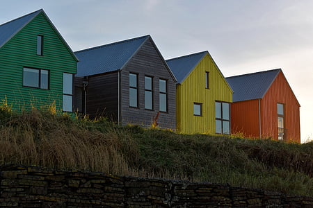 four assorted-color houses thumbnail