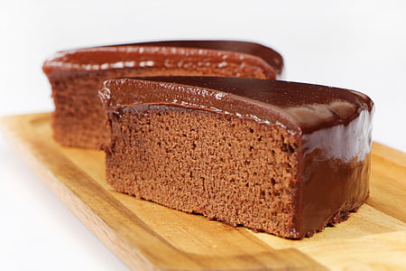 two slices of chocolate cakes on brown wooden board thumbnail
