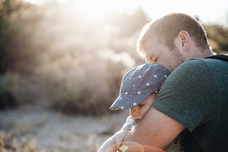man carrying baby outdoors thumbnail