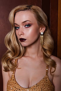 woman in brown beaded top photo thumbnail