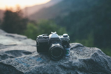 DSLR camera on gray rock thumbnail