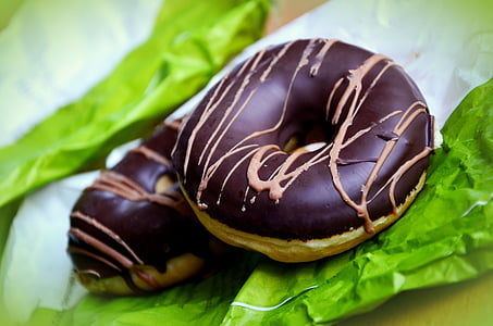 shallow focus photography of two chocolate doughnuts thumbnail