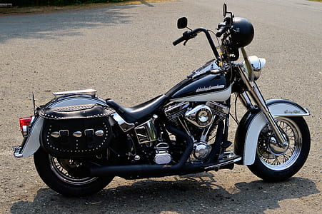 black and gray cruiser motorcycle park on gray pavement thumbnail