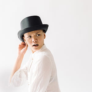 man holding his hat while looking left side thumbnail