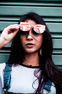 woman holding white sunglasses thumbnail