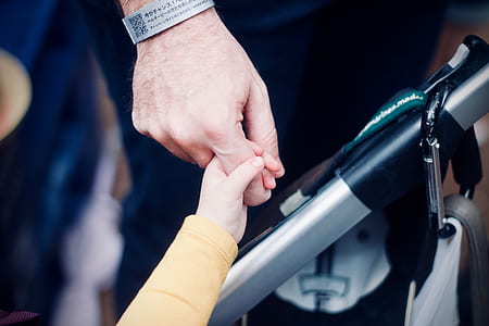 toddler holding man's index finger thumbnail