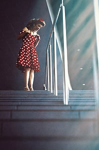 woman in white and red polka-dot dress near handrail thumbnail