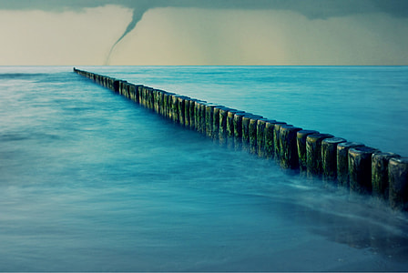 hurricane near wooden barrier along the sea canvas painting thumbnail