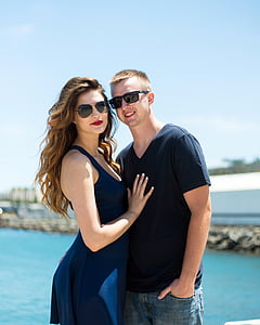 blue dressed woman beside man thumbnail