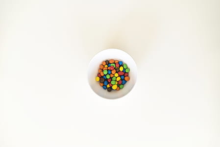 colorful candies in white bowl thumbnail