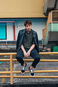 man sitting on metal road rails thumbnail