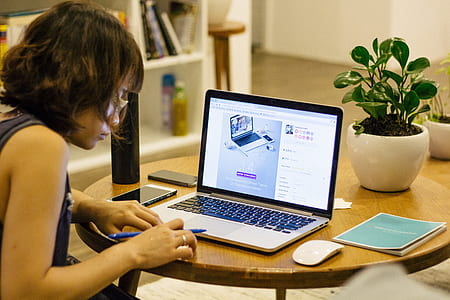 woman sitting in front of MacBook Pro thumbnail