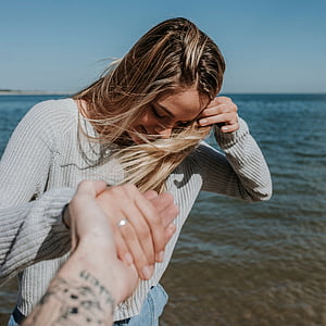 woman holding hand of person thumbnail