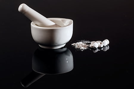 white mortar and pestle on black surface thumbnail
