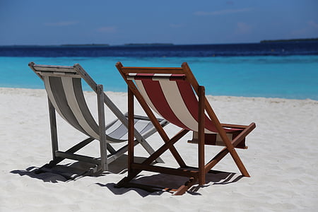 two brown and grey striped loungers beside beach during daytime thumbnail