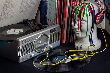 gray and black turntable beside bust with headphones thumbnail