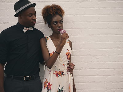 woman and man standing near wall thumbnail