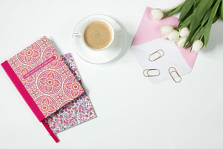 Brown Latte in Ceramic Mug Near Pink and White Floral Textile and White Tulips thumbnail