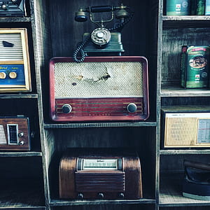 black and gray rotary telephone on red vintage radio thumbnail