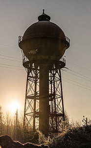 photography of brown metal tank with post at daytime thumbnail