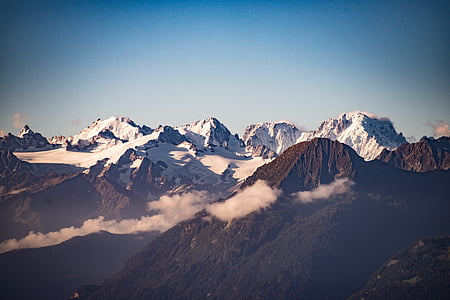 landscape photography of black and white mountains under blue sky at daytime thumbnail