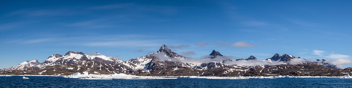 snow mountain beside body of water thumbnail