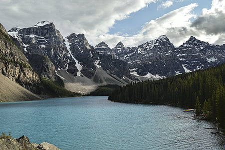 snow capped mountains near river at daytime thumbnail