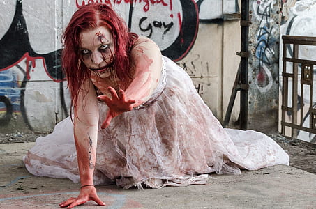 woman in white bridal gown full of fake blood crawling on floor thumbnail