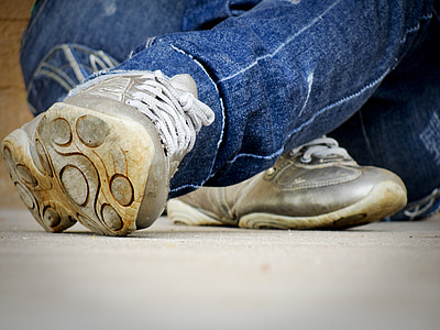 person wearing grey sneakers sitting on floor thumbnail