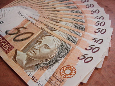 50 banknote collection on brown surface thumbnail