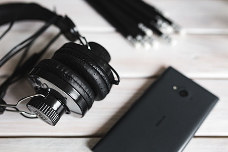 Black smartphone and headphones with various items thumbnail