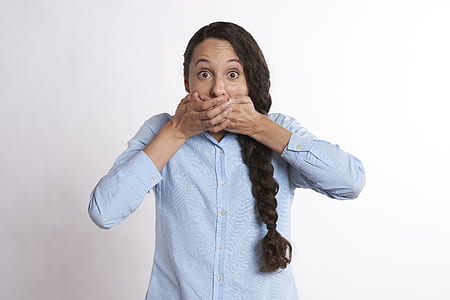 woman wearing white dress shirt covering her mouth thumbnail