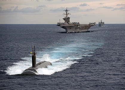 gray submarine and white ship travelling during daytime thumbnail