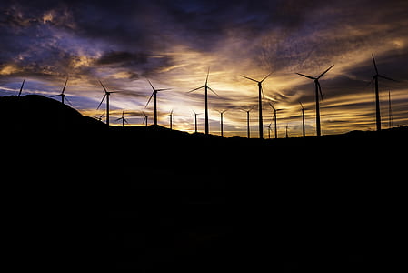 silhouette photo of windmills during sunset thumbnail