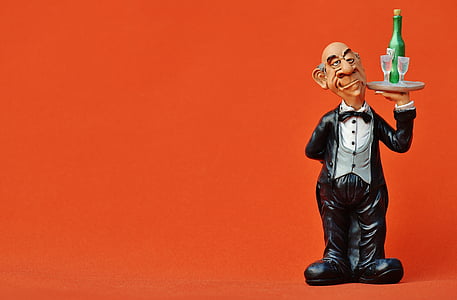 waiter carrying glass of wine on tray thumbnail